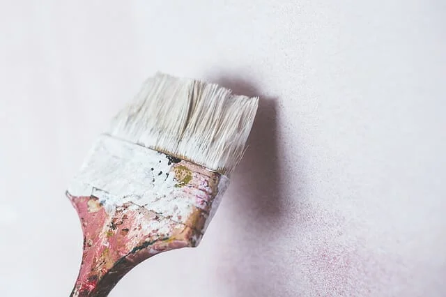 painting the wall with a brush